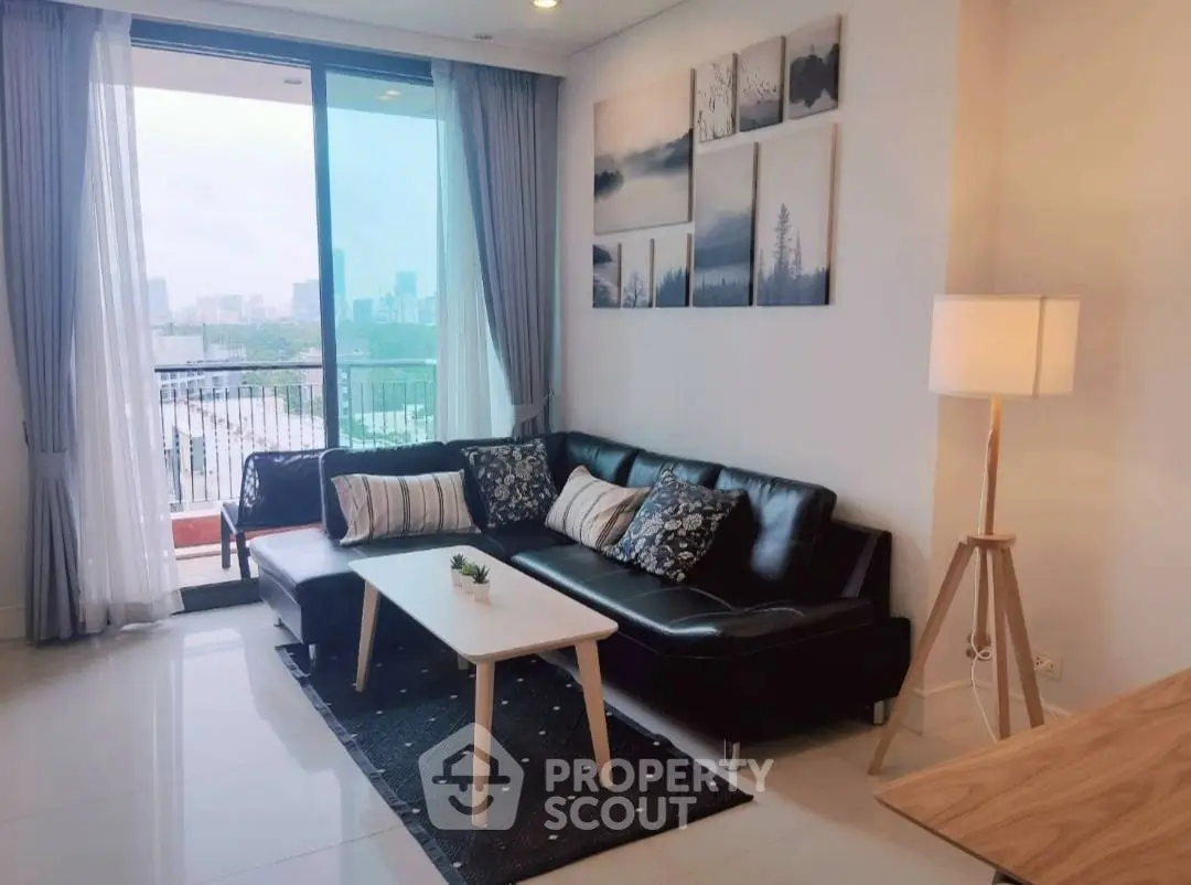 Modern living room with city view, stylish decor, and natural light.