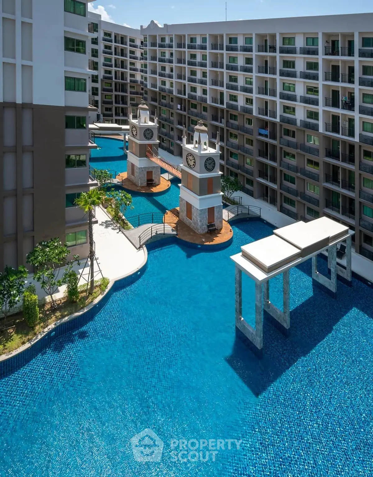 Luxurious condominium with stunning pool and clock tower features, ideal for modern living.