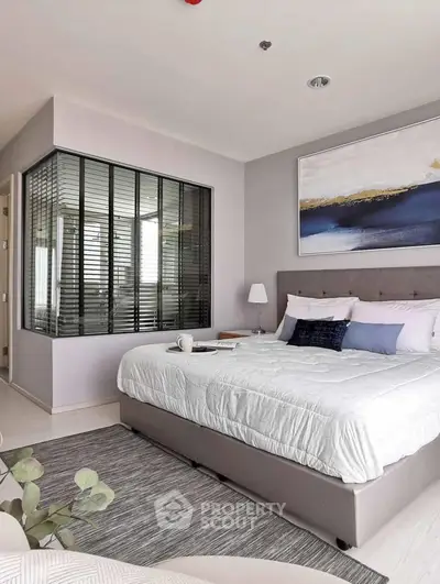 Modern bedroom with stylish decor and large bed in contemporary apartment.