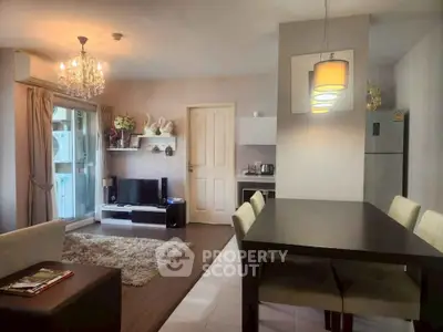 Stylish living room with modern decor and open dining area in a cozy apartment.