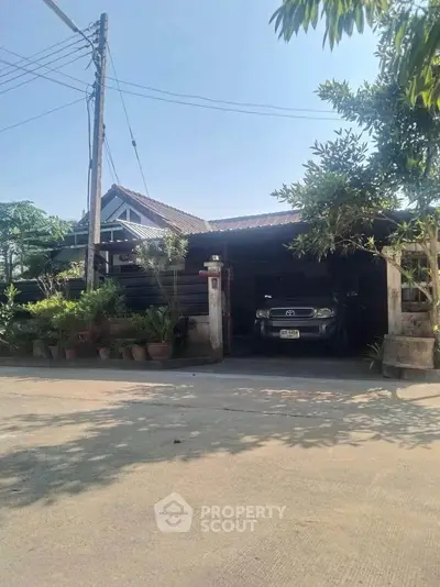 Charming suburban home with lush greenery and spacious driveway