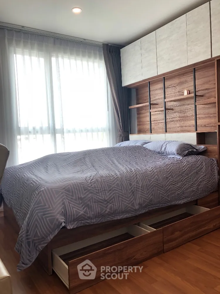 Modern bedroom with stylish wooden bed and ample natural light