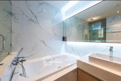 Luxurious modern bathroom with marble tiles and elegant fixtures