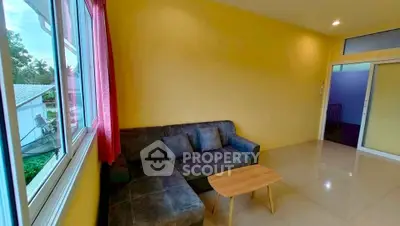 Cozy living room with yellow walls and modern gray sofa