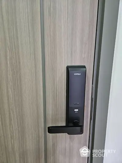 Modern digital door lock on sleek wooden door in contemporary home