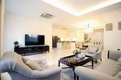 Elegant open-layout living room with modern furniture and dining area