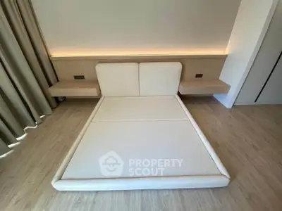Modern minimalist bedroom with sleek built-in bed and ambient lighting