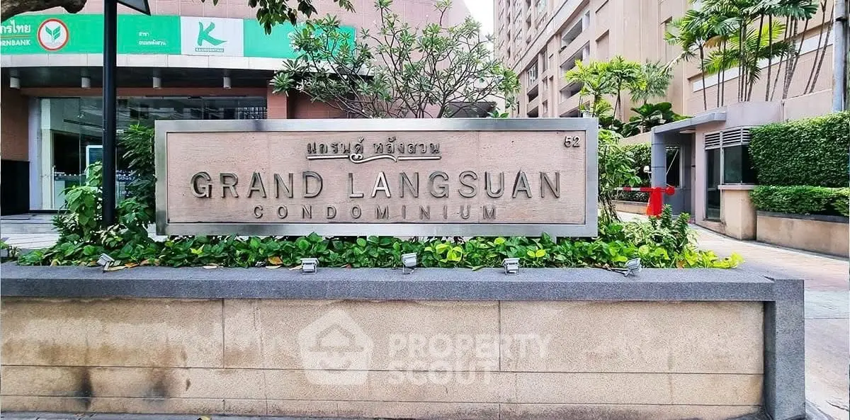 Grand Langsuan Condominium entrance with lush greenery and modern architecture.
