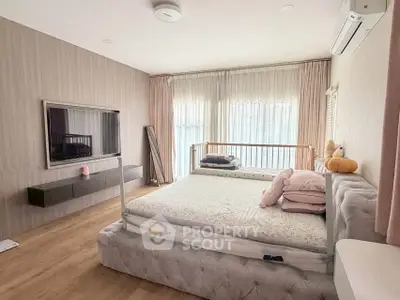 Spacious bedroom with modern decor and large window for natural light