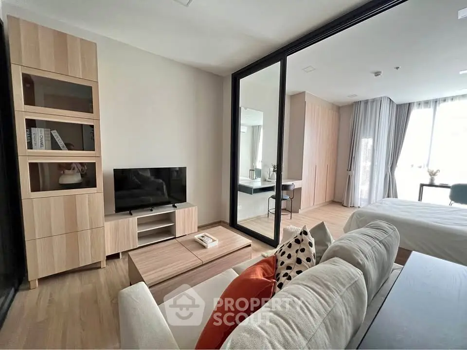 Modern living room with sleek furniture and natural light in a stylish apartment.