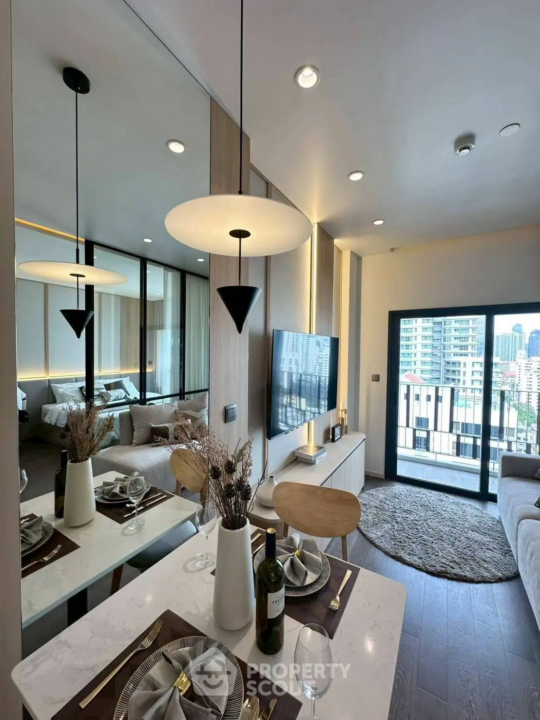 Modern living room with elegant dining area and city view balcony in luxury apartment.