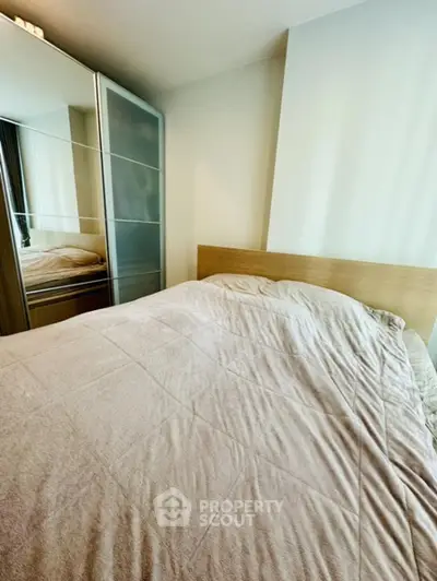 Cozy bedroom with a large comfortable bed and mirrored wardrobe, perfect for restful nights and ample storage space.