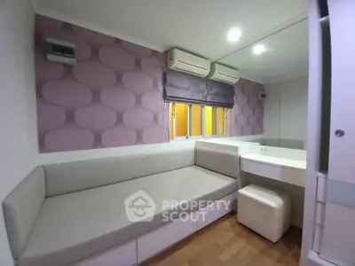 Modern bedroom with stylish wall design and cozy seating area