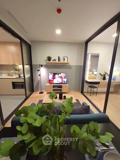 Modern open-plan living room with stylish decor and kitchen view