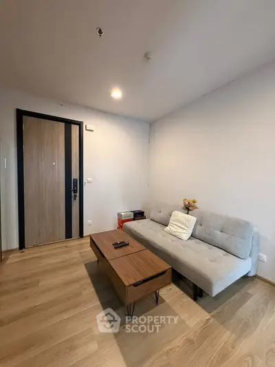 Modern living room with wooden flooring and stylish furniture in a cozy apartment.