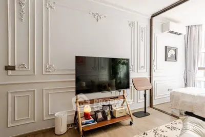 Elegant living room with classic wall moldings and modern TV setup