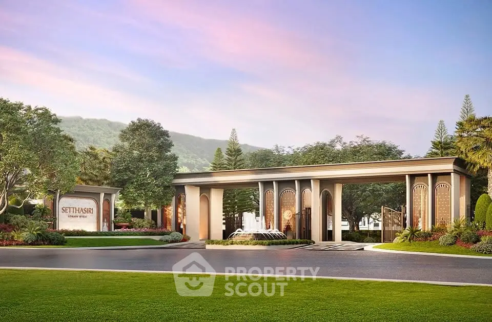 Luxurious gated entrance with elegant landscaping and mountain backdrop