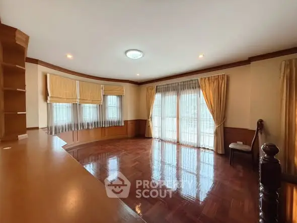 Spacious living room with elegant wooden flooring and large windows