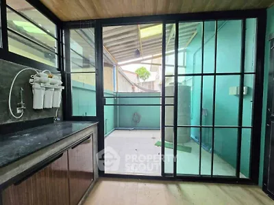 Modern utility area with water filtration system and outdoor access