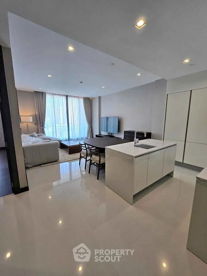 Spacious modern living room with open kitchen and large windows in luxury apartment.