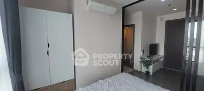 Modern bedroom with air conditioning and sleek design, featuring a wardrobe and TV for ultimate comfort.