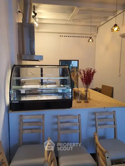 Charming cafe interior with modern decor and cozy seating, perfect for a relaxing coffee break.