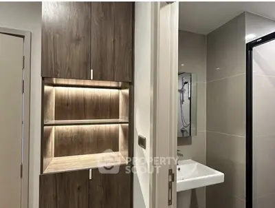 Modern bathroom with sleek design and built-in wooden storage cabinets