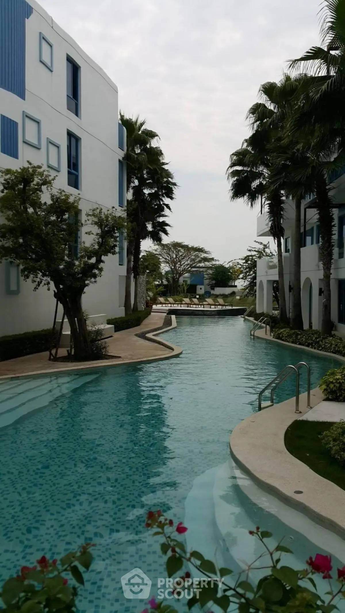 Luxurious residential pool area with modern architecture and lush greenery