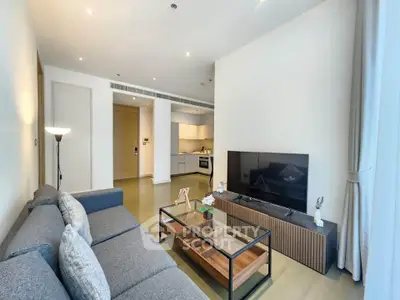 Modern living room with sleek furniture and open kitchen layout