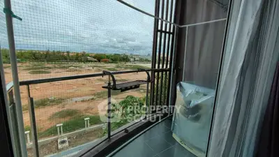 Spacious balcony with panoramic view and protective netting in modern apartment.