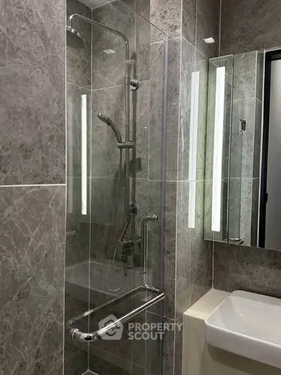 Modern bathroom with sleek shower and elegant marble tiles