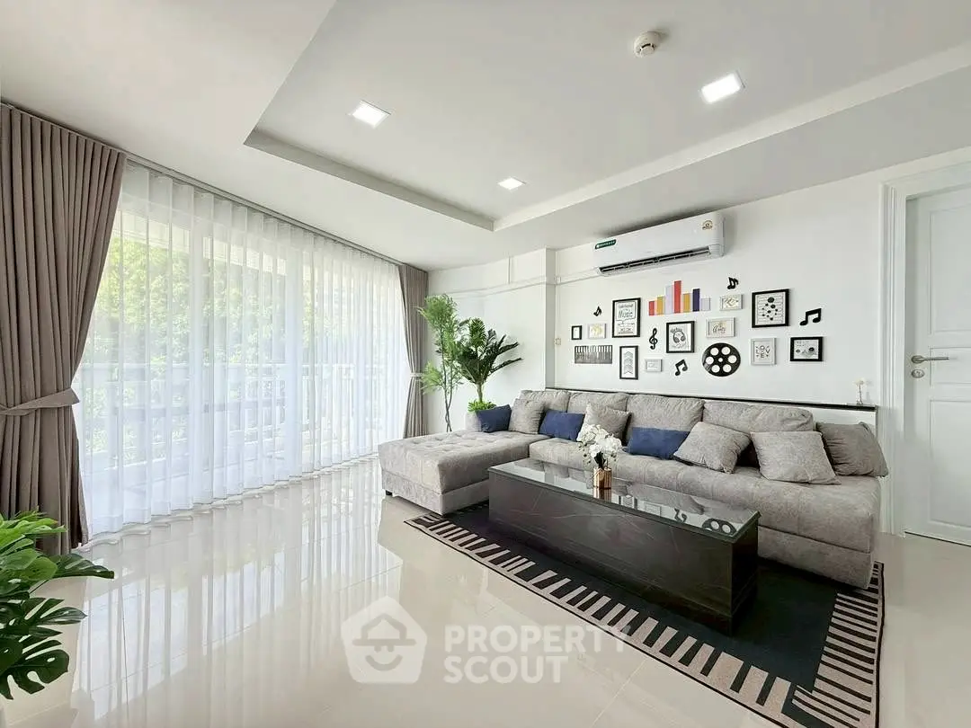 Spacious modern living room with large windows and stylish decor