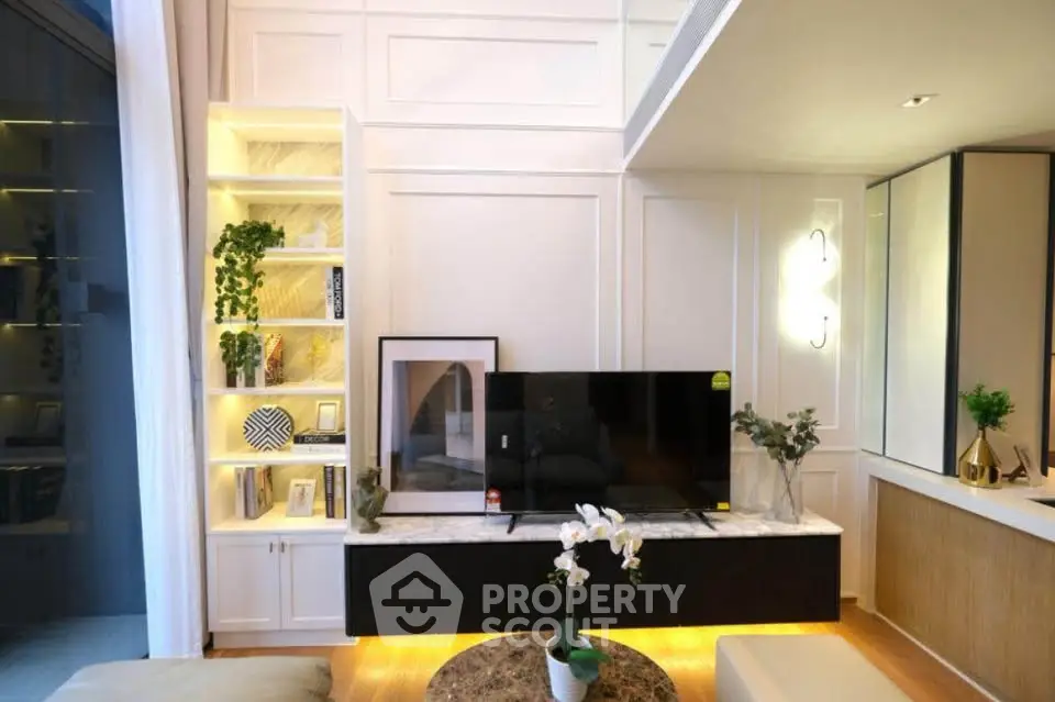 Modern living room with stylish decor, built-in shelves, and a sleek TV setup, perfect for contemporary living.