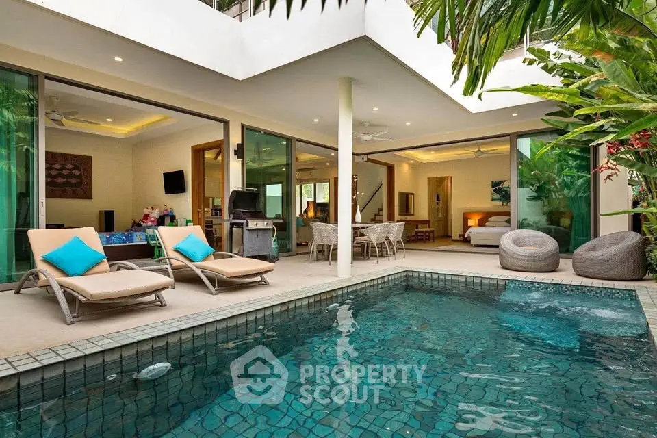 Luxurious villa with private pool and modern outdoor seating area, perfect for relaxation and entertainment.