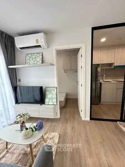 Modern living room with stylish decor and open kitchen layout in a contemporary apartment.
