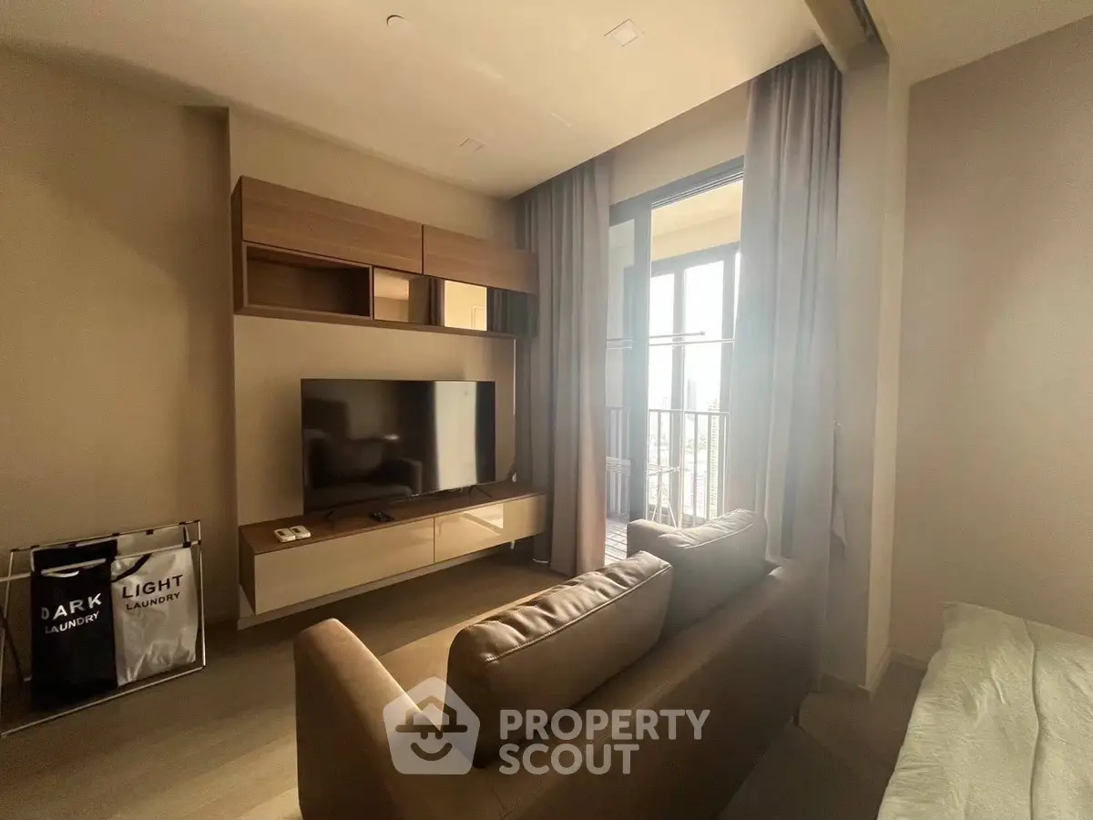 Modern living room with sleek furniture and balcony view, perfect for urban living.