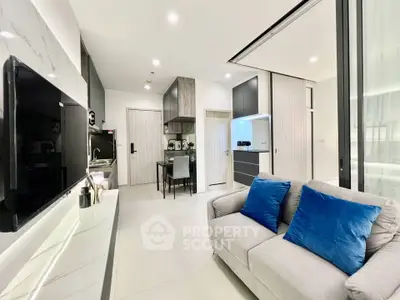 Modern open-plan living room with sleek kitchen and cozy seating area.