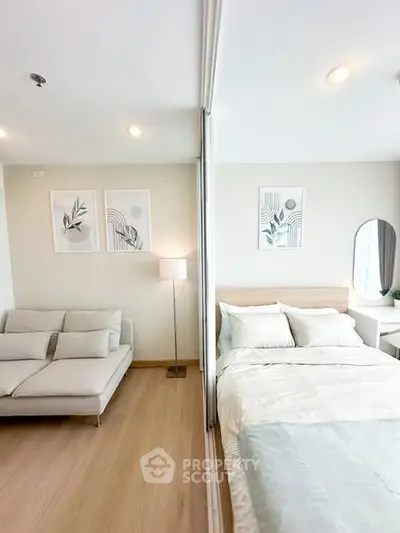 Modern studio apartment with cozy living area and stylish bedroom decor.