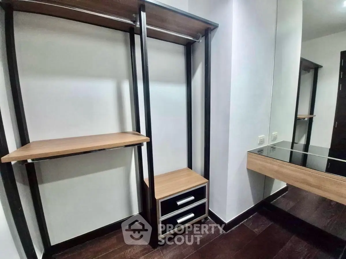 Spacious walk-in closet with modern shelving and mirror