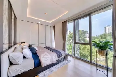 Luxurious bedroom with large windows offering stunning city views and modern decor.
