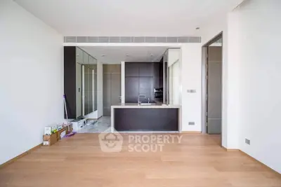 Modern open-plan kitchen with sleek design and wooden flooring