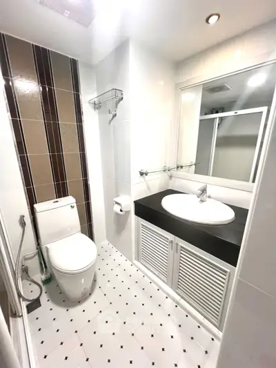 Modern bathroom with sleek design, featuring a stylish sink and elegant tile work.