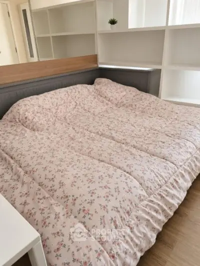 Cozy bedroom with floral bedding and modern shelving unit