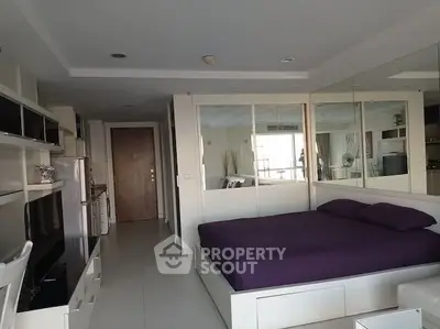 Modern studio apartment with mirrored walls and sleek furnishings