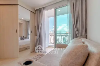 Modern living room with balcony view and cozy sofa in bright apartment.