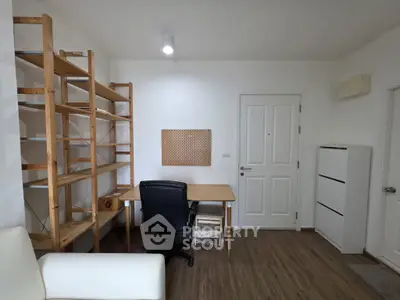 Modern study room with wooden shelves and sleek desk in a minimalist design.