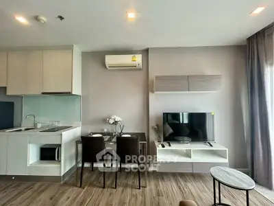 Modern living room with sleek furniture and open kitchen layout in a stylish apartment.