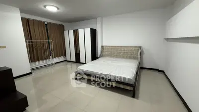 Spacious bedroom with modern wardrobe and large bed in minimalist design.