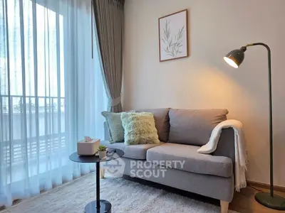 Cozy living room with modern sofa, floor lamp, and balcony view