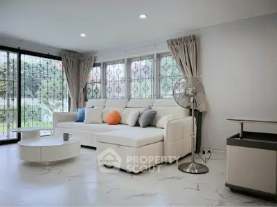 Spacious living room with modern white sofa and elegant decor